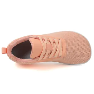 Top view of breathable orange fly-knit barefoot sneakers with a wide toe box design.
