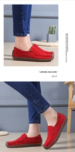 Elegant red cowhide suede flat loafers for women displayed in a lifestyle setting