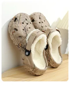 Close-up of camouflage clogs featuring warm white fleece lining and adjustable heel strap