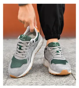 Macro detail of men's lightweight grey and green casual running sneakers outdoors
