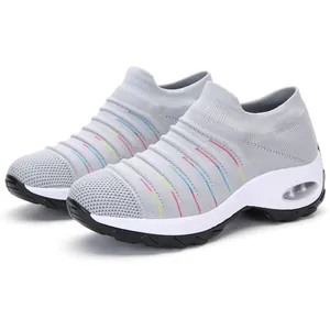 Detail of gray knitted sock sneakers with colorful stripes and air cushion sole.