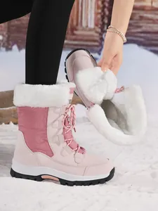 Close-up of pink outdoor snow boots for women featuring thick white faux fur lining