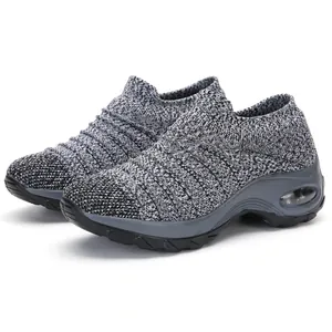 Close-up detail of grey knit sock shoes featuring a supportive air cushion sole