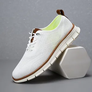 Close-up detail of lightweight breathable white mesh sneakers with brown leather accents