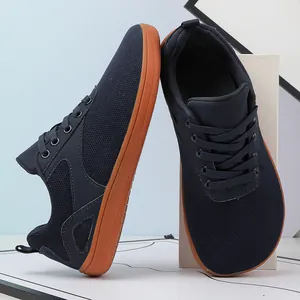 Detailed view of breathable navy fly-knit upper and wide toe gum sole