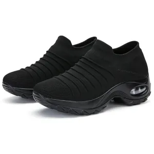 Side view of black knit slip-on sock sneakers featuring a thick air cushion sole.