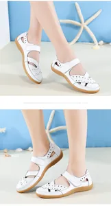 Detailansicht weißer Leder-Sandalen mit Lochmuster, flacher Sohle und Klettverschluss