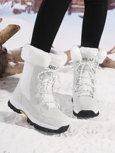 Detail view of white outdoor snow boots with faux fur lining and lace-up design