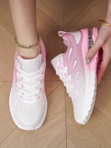 Detailed view of pink and white breathable mesh running shoes for women