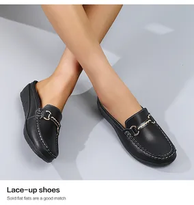 Detailaufnahme bequemer schwarzer Leder-Loafer mit Keilabsatz und Metallakzent.