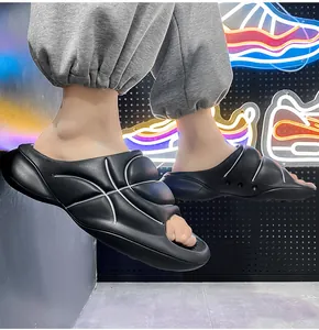 Detail view of black men's EVA slippers with comfortable thick soles and basketball design.