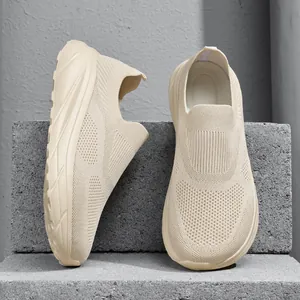 Detail shot of men's beige breathable fly-knit slip-on sneakers with wide toe box.