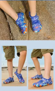 Blue kids water shoes with dinosaur patterns shown in a beach setting for outdoor play