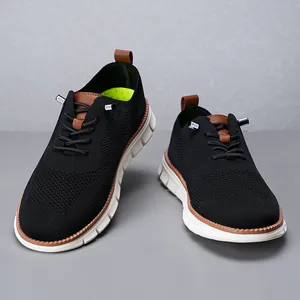 Close-up of breathable black knit sneakers with white soles and brown leather details.