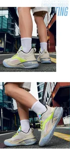Mid-top men's basketball shoes with neon accents shown on a model in urban street.