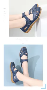 Detailed view of blue leather sandals with hollow-out pattern and velcro strap