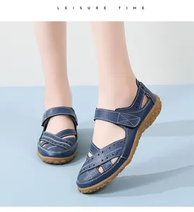 Detailed view of women's blue hollow-out leather sandals worn on feet for comfort