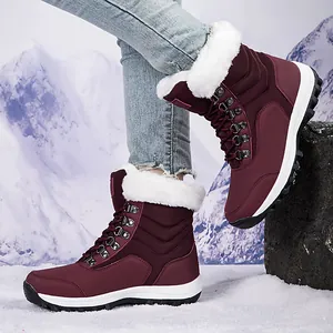 Burgundy women's snow boots with white faux fur lining and lace-up design