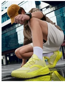 Detail of neon yellow mid-top basketball shoes for teens on city street.