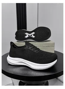 Detail view of black breathable fly-knit running shoes with wide-last design