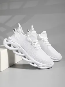 Close-up detail of white mesh sports shoes featuring unique wavy hollowed-out soles
