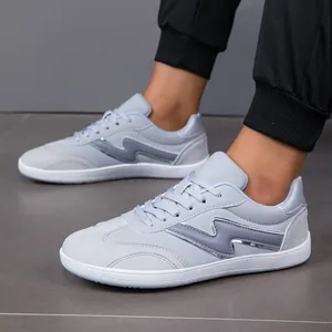 Close-up detail of light grey men's casual sneakers with stylish wavy side pattern