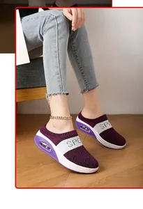 Macro view of purple fly-knit platform mules for women featuring a white sport strap detail