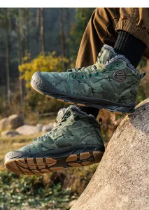 Mens waterproof camouflage snow boots featuring warm fleece lining and durable non-slip soles