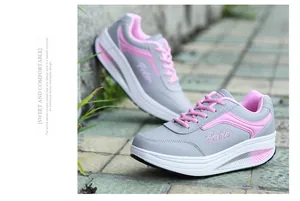 Side view of grey and pink women's thick-sole rocking shoes for walking