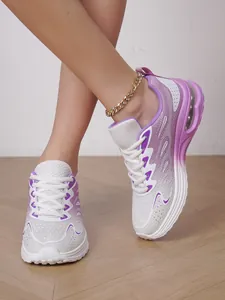 Detail view of purple gradient mesh running shoes with air cushion sole and gold anklet