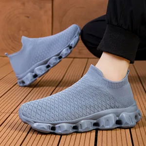 Breathable grey knit slip-on sneakers for men and women with textured popcorn style soles.