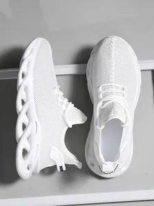 Side and top-down view of white mesh men's running shoes with wavy cushioned sole