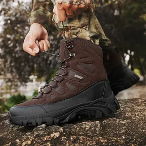 Rugged brown and black tactical hiking boots for men shown in an outdoor rocky setting