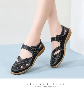 Close-up view of black leather hollow sandals with comfortable soft rubber soles.