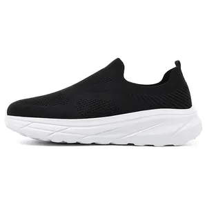 Side view of a black breathable fly-knit slip-on walking shoe with thick white sole