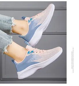 Detail view of pink and blue fly-knit breathable running shoes with EVA sole