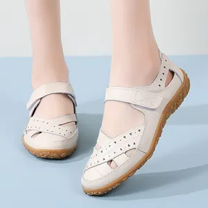Elegant beige leather hollow out sandals for women featuring adjustable velcro straps