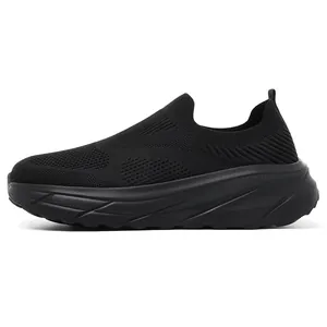 Side profile of men's black breathable flyknit slip-on walking sneakers with wide fit