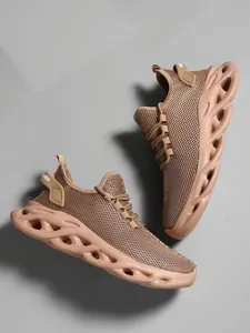 Close-up of tan men's mesh running shoes with unique hollowed-out shock-absorbing soles