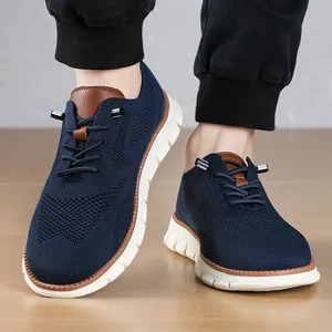 Detail of navy blue breathable mesh men's loafers with brown leather accents and white sole