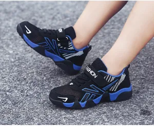 Close-up of boys' breathable mesh running shoes in black and blue on pavement