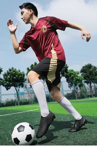 Dynamic action shot of men's low-cut soccer shoes on a professional artificial turf field