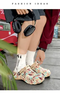 Detailed view of men's tropical leaf print clogs featuring an adjustable beige sport strap