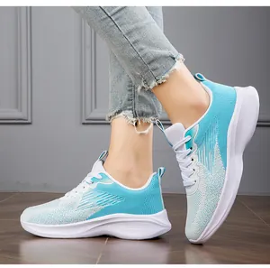Detailed side view of breathable teal fly-knit women's sports shoes with white sole