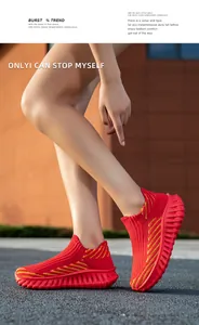 Detailed macro view of bright red fly-knit sock sneakers featuring yellow stripes
