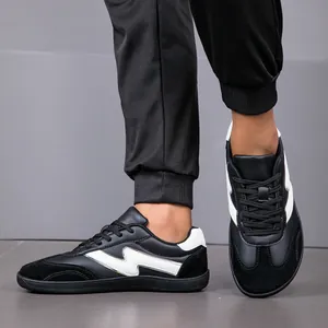 Detailed view of men's black wide-toe casual sneakers featuring white lightning accents