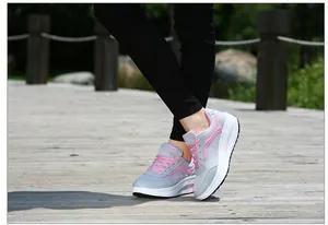 Side view of breathable mesh rocker platform sneakers for women in grey and pink
