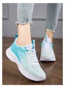 Detailed close-up of lightweight blue and white breathable fly-knit sneakers on feet.