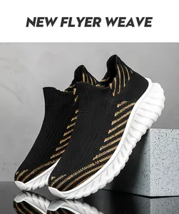 Detail view of breathable black and gold fly-weave slip-on sock sneakers