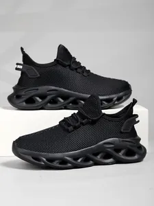 Stylish black mesh running shoes featuring a unique hollowed-out wave sole design
